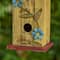 Glitzhome® 11.75" Yellow Washed 3D Metal Flowers Distressed Wood Cottage Birdhouse